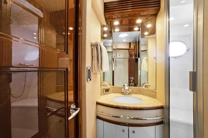 Her Endeavour Yacht Photos Pics Luxurious bathroom interior of 2008 Marquis 690 yacht with elegant fixtures and lighting.