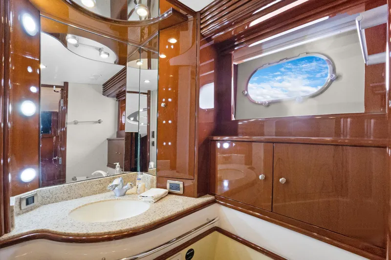 Her Endeavour Yacht Photos Pics Luxurious 2008 Marquis 690 yacht bathroom with elegant wood finish and ocean view.