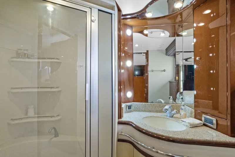 Her Endeavour Yacht Photos Pics Luxurious bathroom in 2008 Marquis 690 yacht with elegant fixtures and modern design.