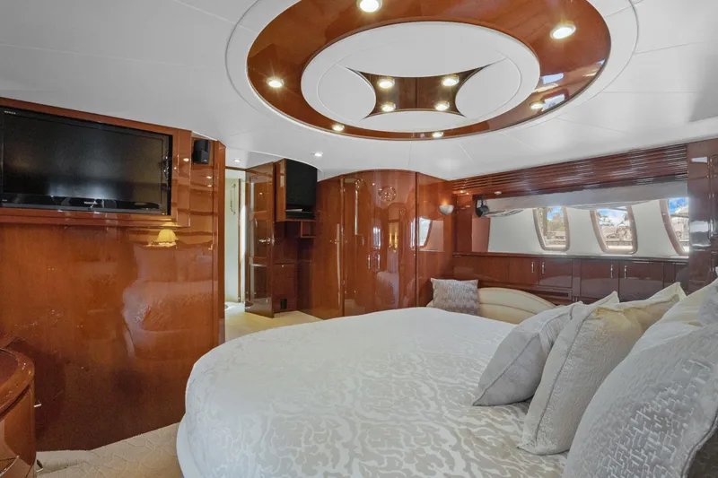 Her Endeavour Yacht Photos Pics Luxurious 2008 Marquis 690 yacht bedroom with elegant wood finishes and modern amenities.
