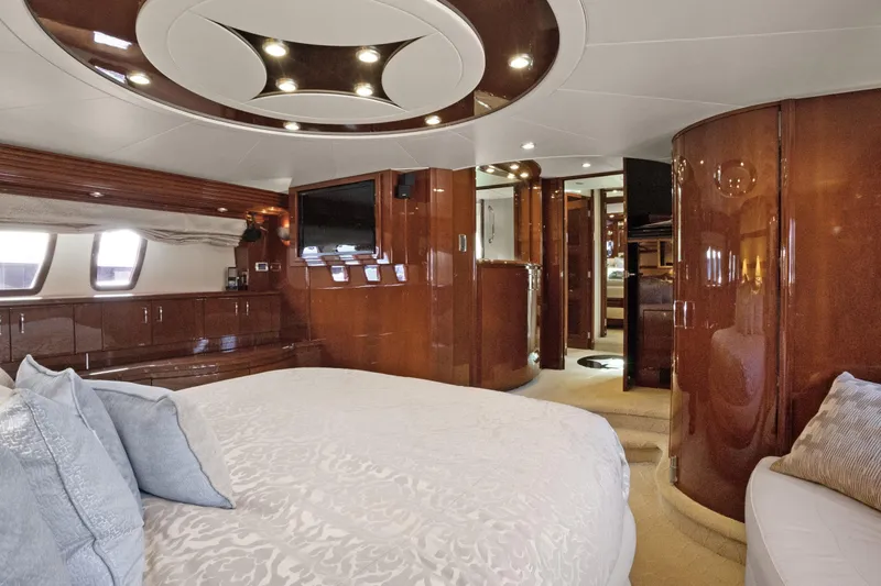 Her Endeavour Yacht Photos Pics Luxurious 2008 Marquis 690 yacht interior with elegant wood finishes and plush bedding.