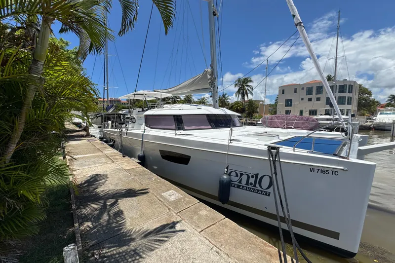 Ten:10 Yacht Photos Pics 2017 Fountaine Pajot SABA 50 catamaran docked, surrounded by tropical scenery.