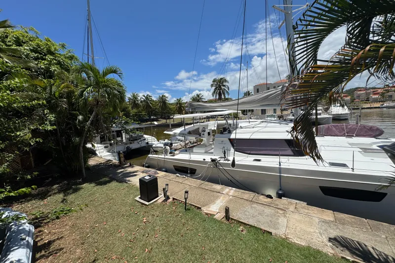 Ten:10 Yacht Photos Pics 2017 Fountaine Pajot SABA 50 catamaran docked in a tropical marina setting.