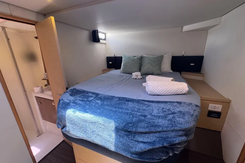 Ten:10 Yacht Photos Pics Cozy bedroom in 2017 Fountaine Pajot SABA 50 yacht with modern decor and ensuite bathroom.