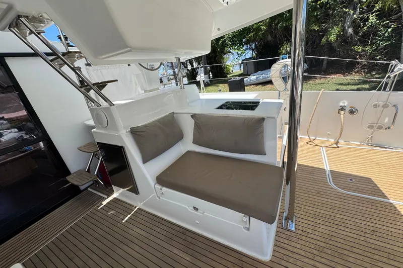 Ten:10 Yacht Photos Pics 2017 Fountaine Pajot SABA 50 yacht deck with cushioned seating and wooden flooring.