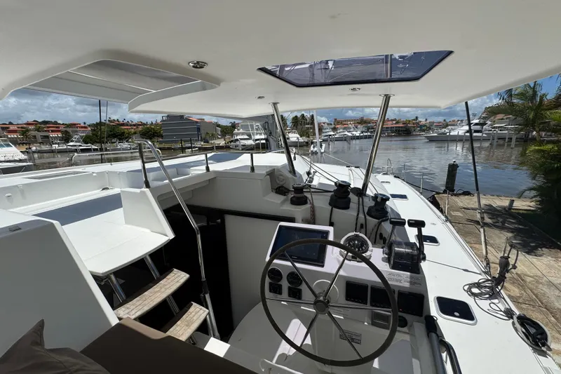 Ten:10 Yacht Photos Pics 2017 Fountaine Pajot SABA 50 yacht cockpit with steering wheel, docked in marina.