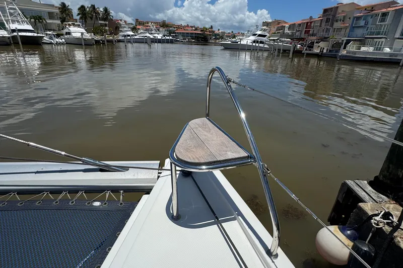 Ten:10 Yacht Photos Pics 2017 Fountaine Pajot SABA 50 catamaran docked in a marina with waterfront view.