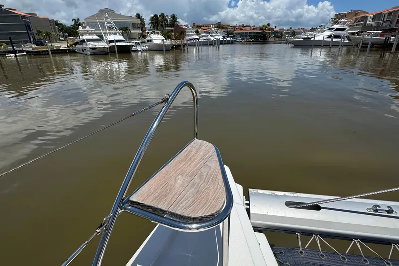 Ten:10 Yacht Photos Pics 2017 Fountaine Pajot SABA 50 catamaran docked in a marina with other boats.