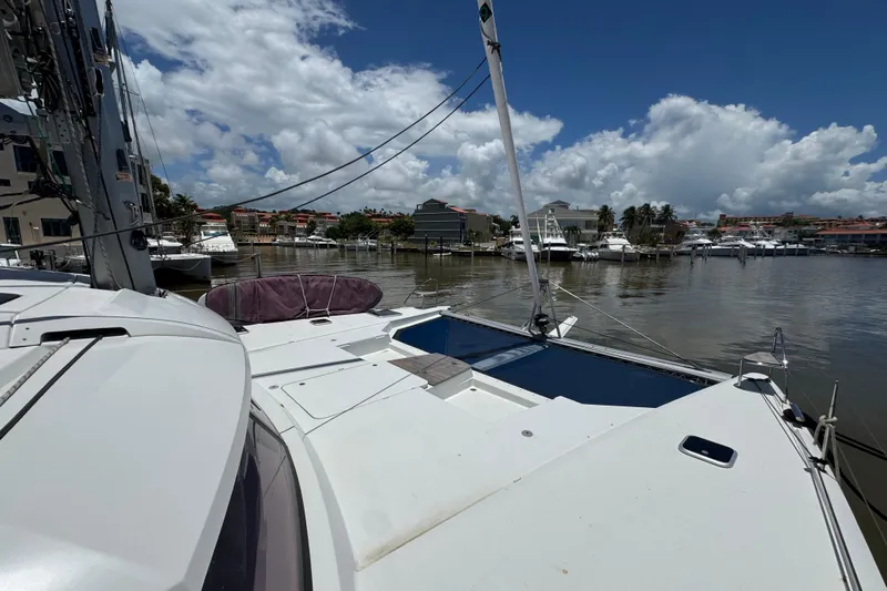 Ten:10 Yacht Photos Pics 2017 Fountaine Pajot SABA 50 catamaran docked in a marina under a blue sky.