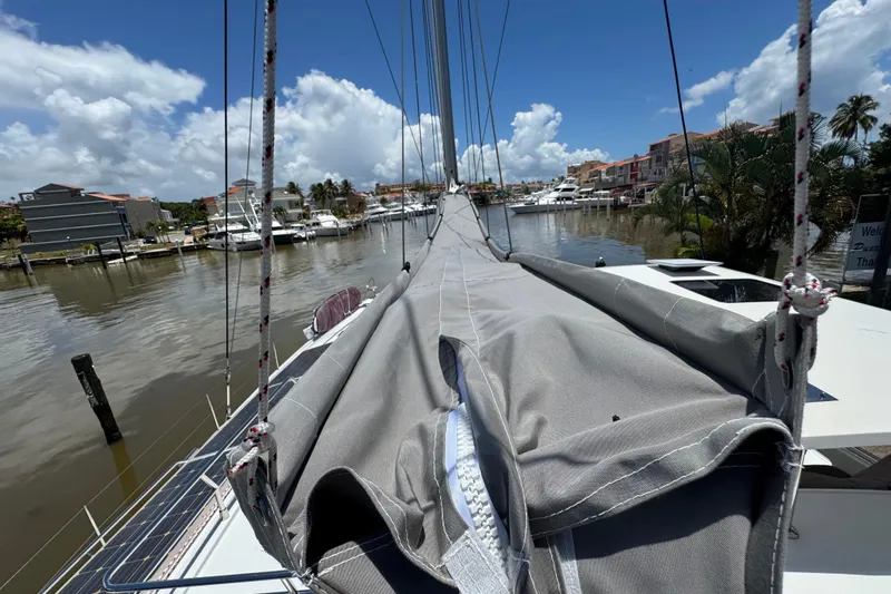 Ten:10 Yacht Photos Pics 2017 Fountaine Pajot SABA 50 catamaran docked in a sunny marina, surrounded by boats.