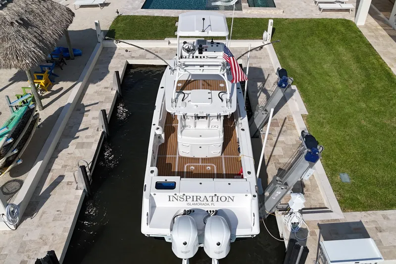  Yacht Photos Pics 2018 Everglades 335 Center Console boat docked, aerial view, with American flag.