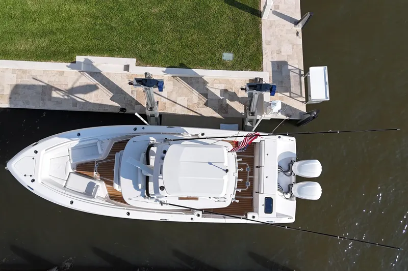  Yacht Photos Pics Overhead view of 2018 Everglades 335 Center Console boat docked by grassy area.