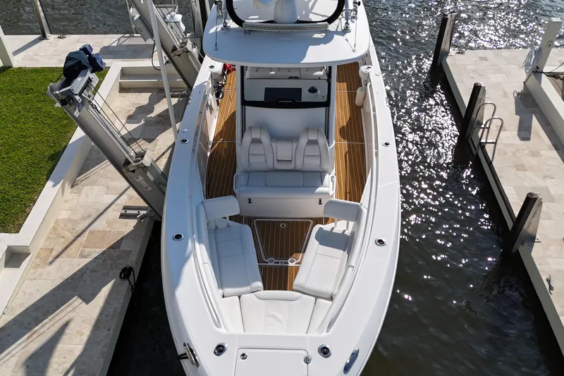  Yacht Photos Pics 2018 Everglades 335 Center Console boat docked, featuring spacious seating and sleek design.