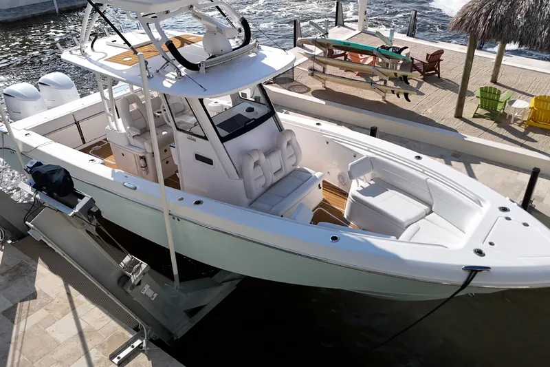 Yacht Photos Pics 2018 Everglades 335 Center Console boat docked by waterfront with seating and dual engines.