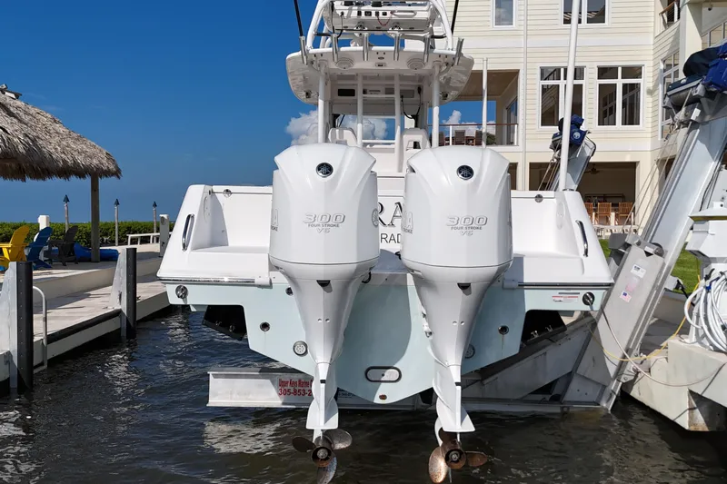  Yacht Photos Pics 2018 Everglades 335 Center Console boat with dual Yamaha 300 engines docked by a waterfront home.