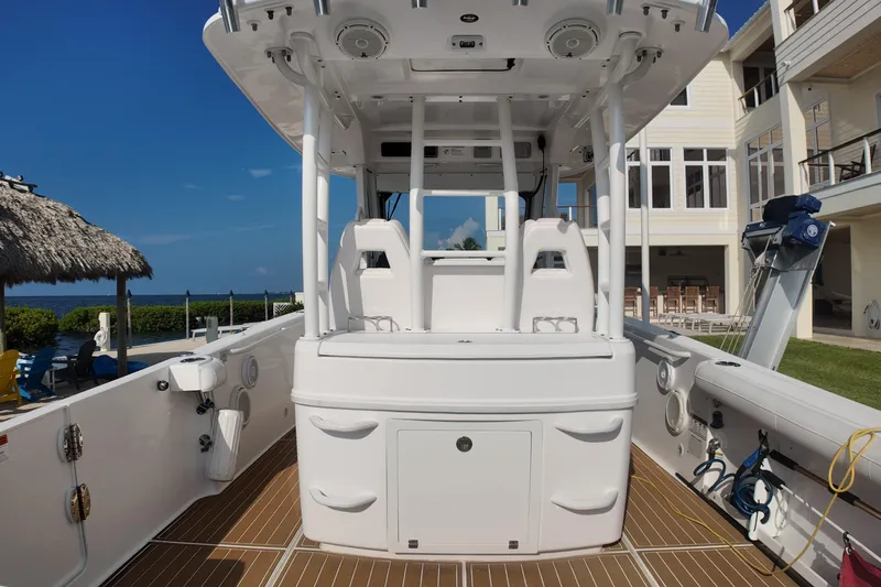  Yacht Photos Pics 2018 Everglades 335 Center Console boat docked near waterfront home.