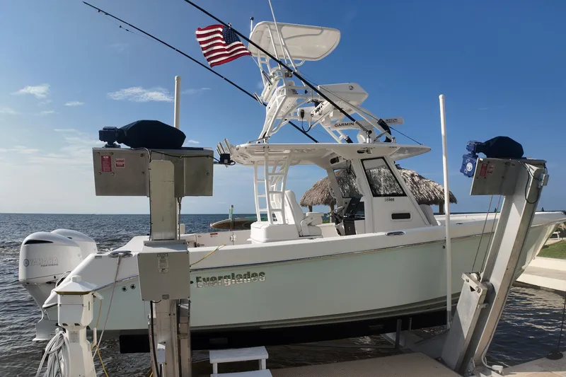  Yacht Photos Pics 2018 Everglades 335 Center Console boat docked with American flag, ocean backdrop.