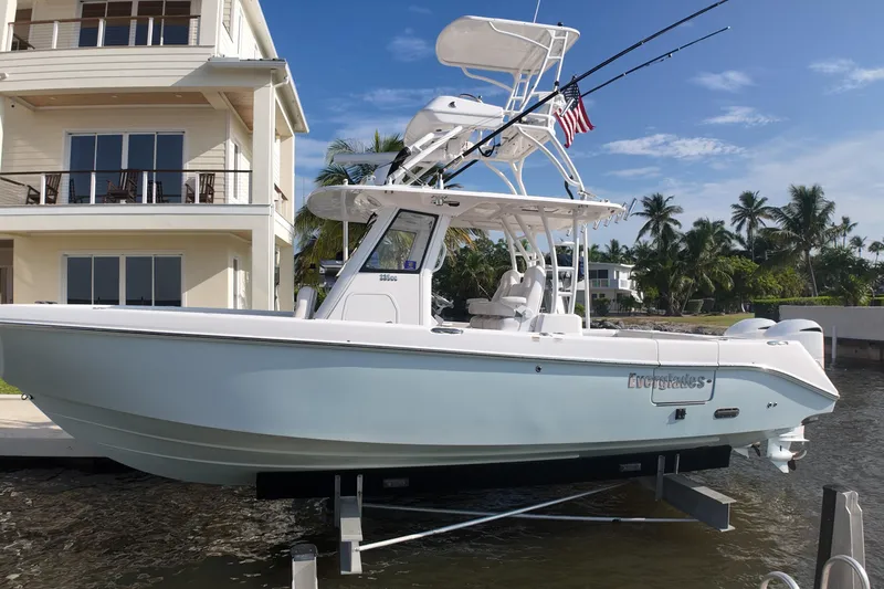  Yacht Photos Pics 2018 Everglades 335 Center Console boat docked near waterfront home.