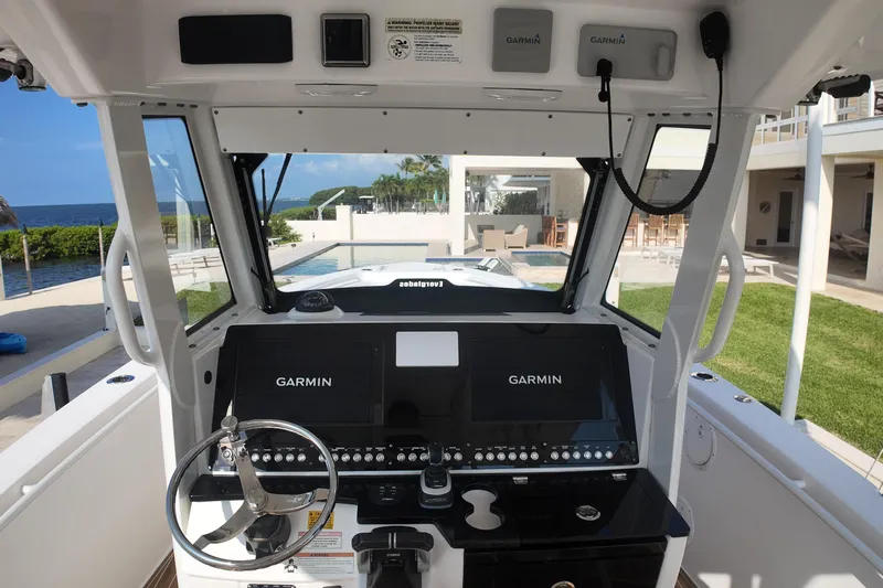  Yacht Photos Pics 2018 Everglades 335 Center Console boat cockpit with Garmin navigation system, ocean view.