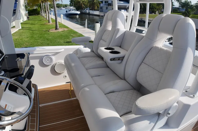  Yacht Photos Pics Luxurious seating on 2018 Everglades 335 Center Console boat, featuring plush white upholstery.
