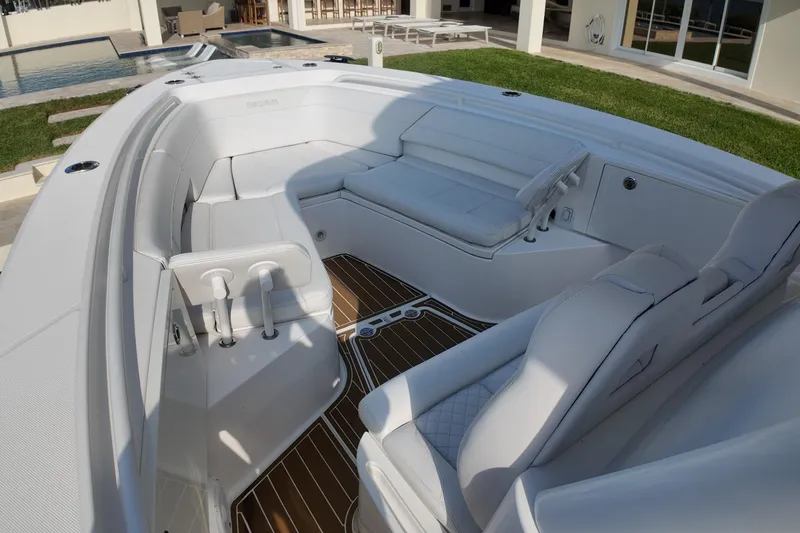  Yacht Photos Pics 2018 Everglades 335 Center Console boat interior with white seating and wood flooring.