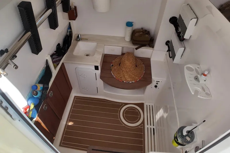  Yacht Photos Pics 2018 Everglades 335 Center Console cabin interior with sink, storage, and accessories.