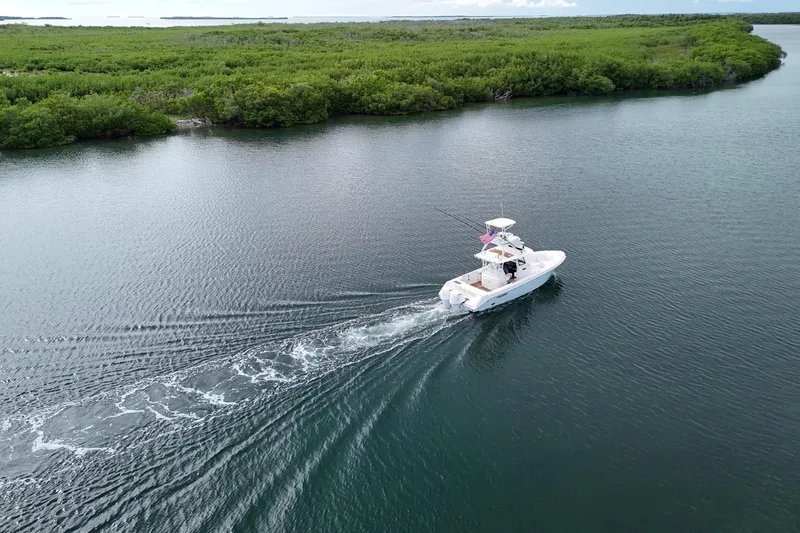 Yacht Photos Pics 2018 Everglades 335 Center Console boat cruising in scenic waterway.