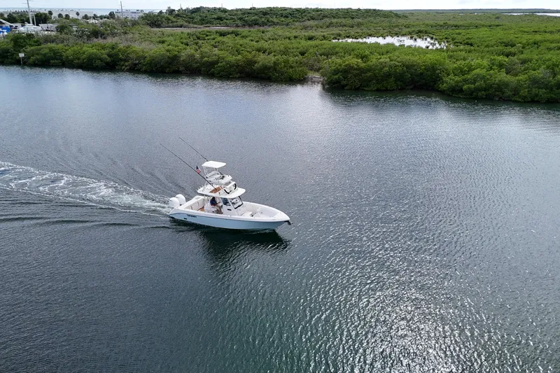  Yacht Photos Pics 2018 Everglades 335 Center Console boat cruising on a serene waterway.