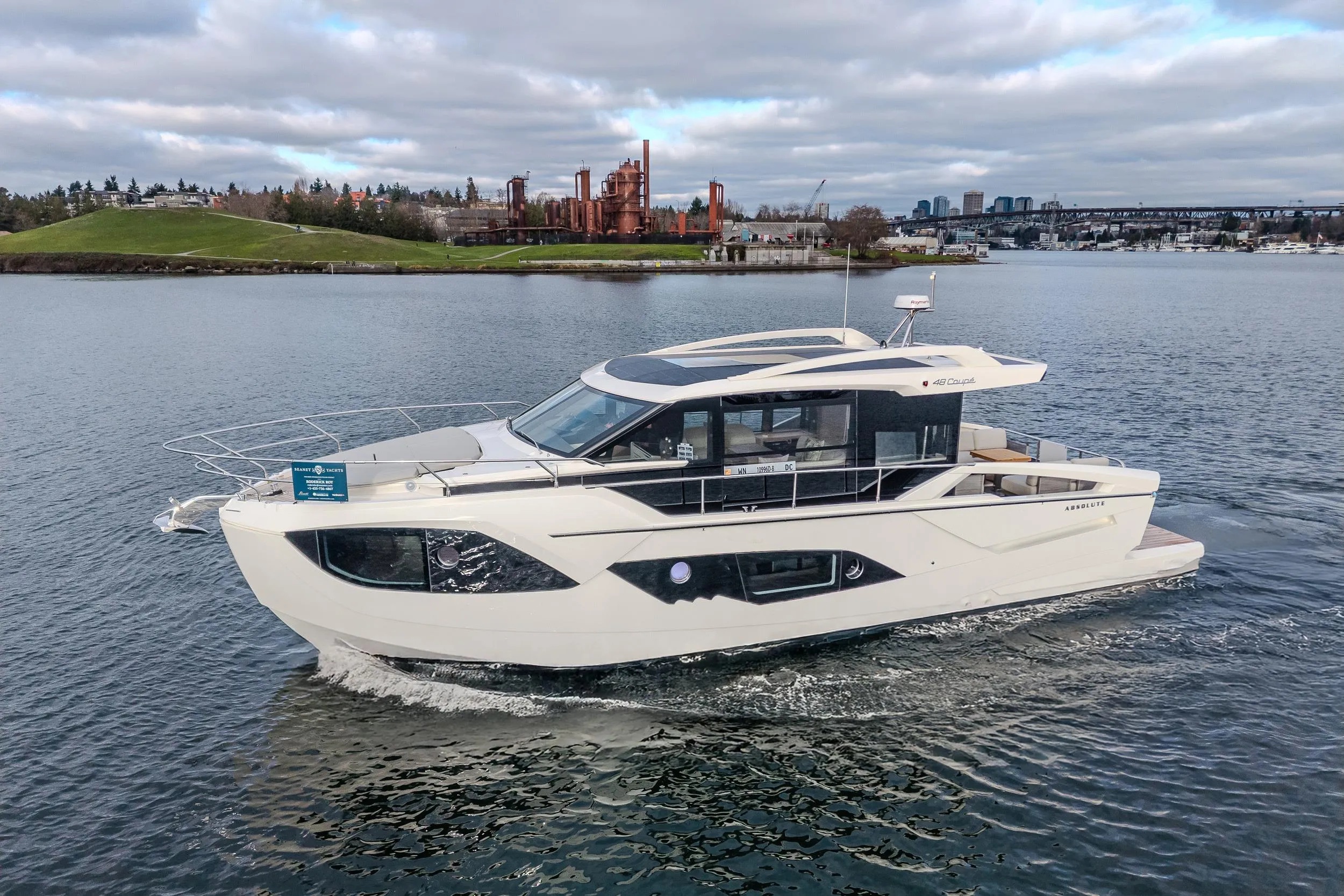 Luxury 2026 Absolute 48 Coupe yacht cruising on a scenic waterway.