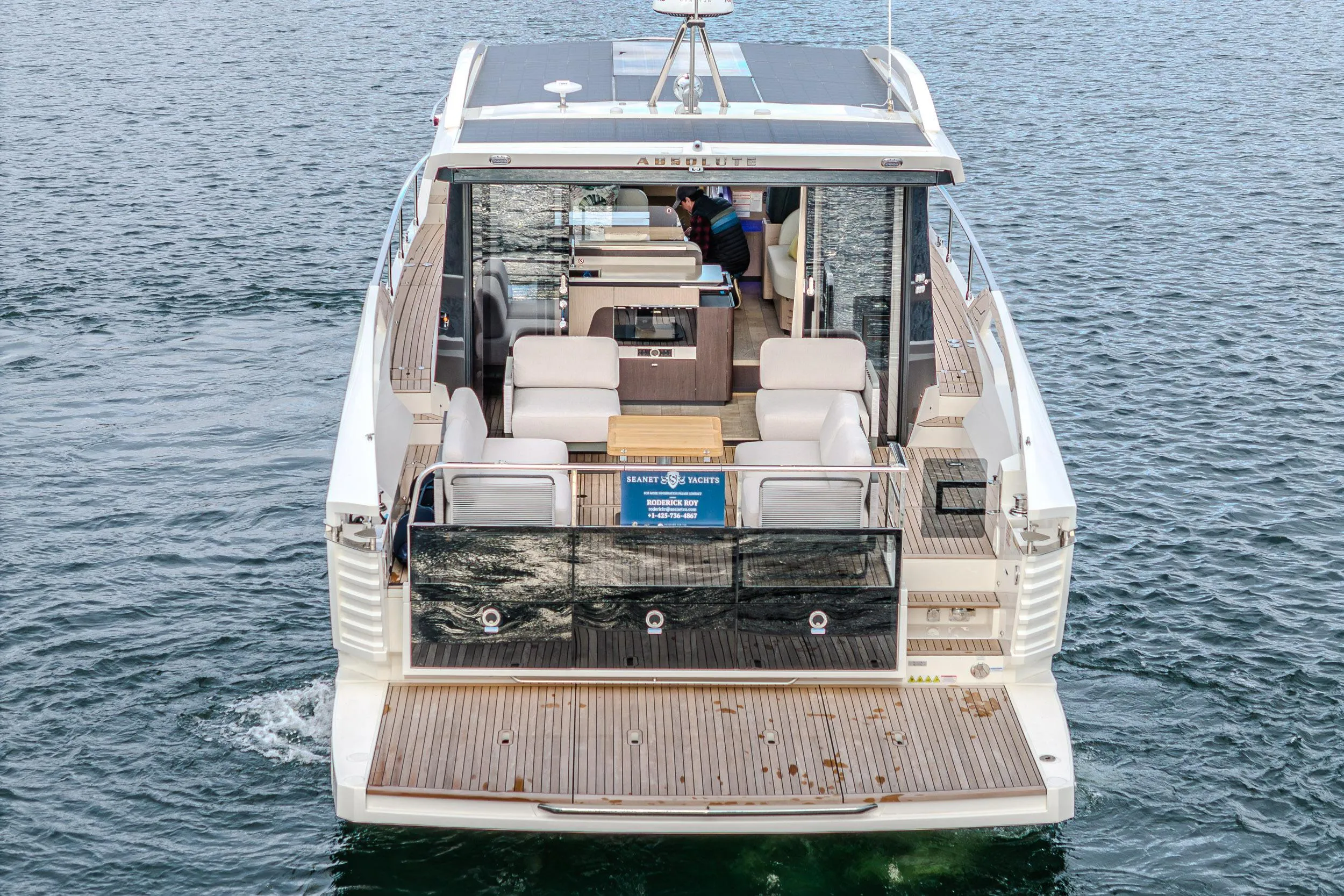 2026 Absolute 48 Coupe yacht on water, showcasing spacious deck and modern design.