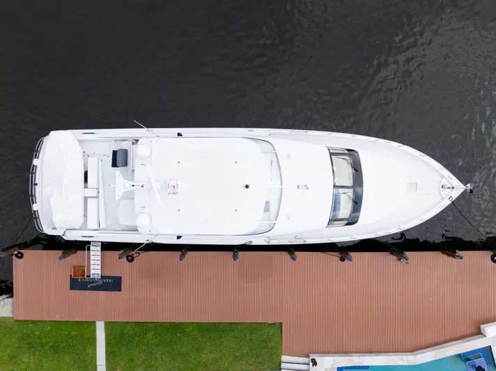 Corporate Approved 2 Yacht Photos Pics Aerial view of 2005 Hatteras 80 Motor Yacht docked by wooden pier.
