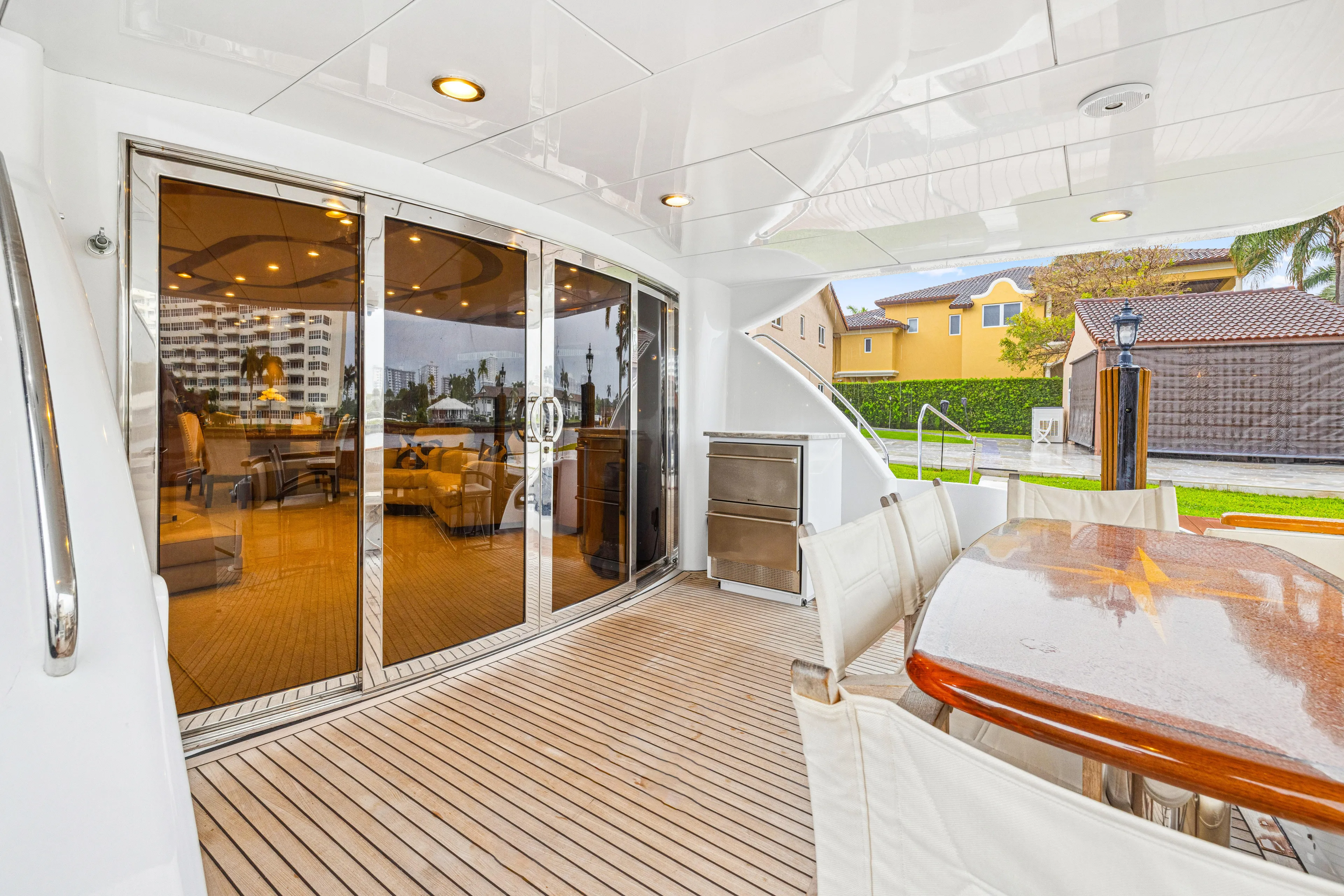 Corporate Approved 2 Yacht Photos Pics Luxurious 2005 Hatteras 80 Motor Yacht deck with elegant seating and glass doors.
