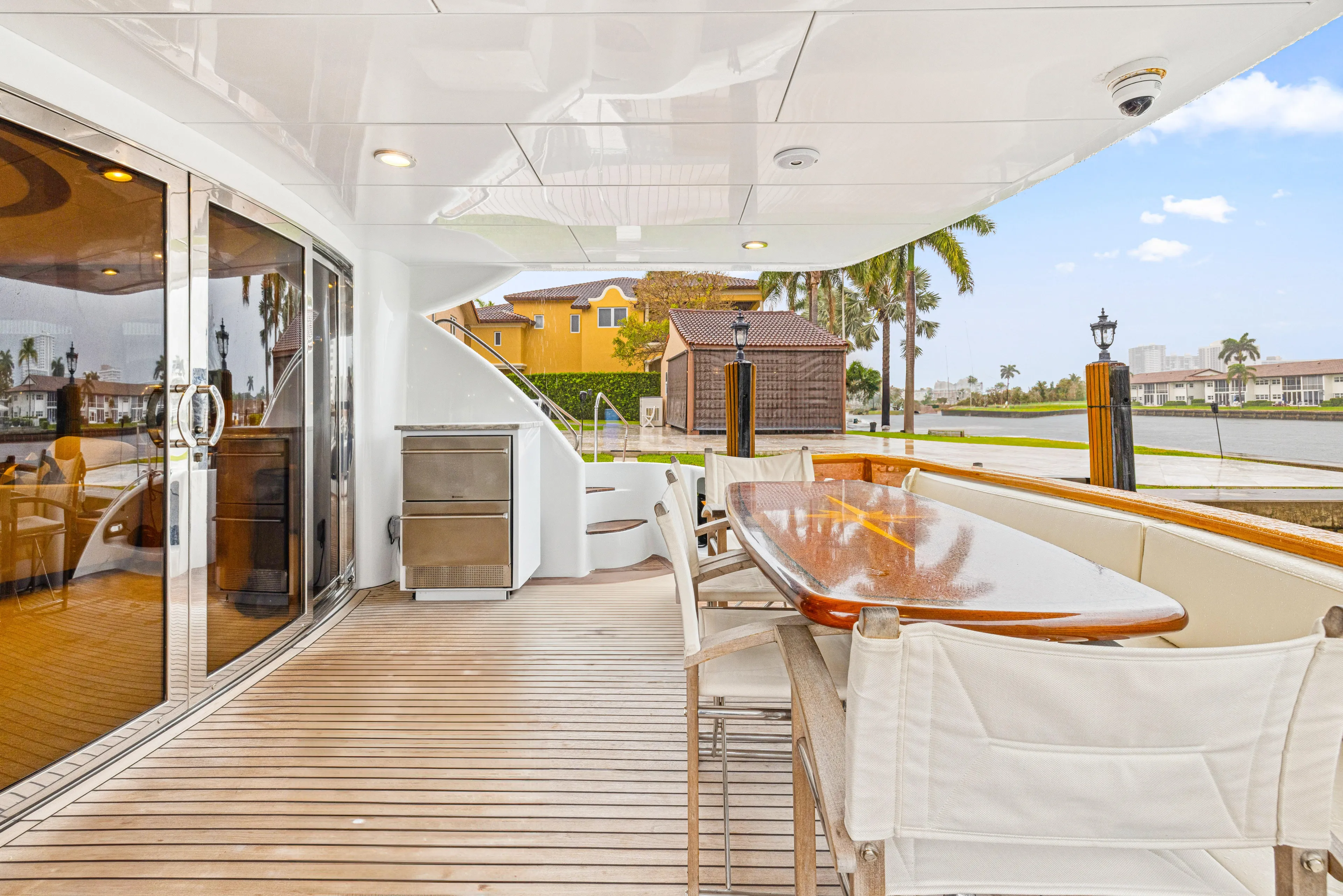 Corporate Approved 2 Yacht Photos Pics Outdoor deck of 2005 Hatteras 80 Motor Yacht with seating and waterfront view.