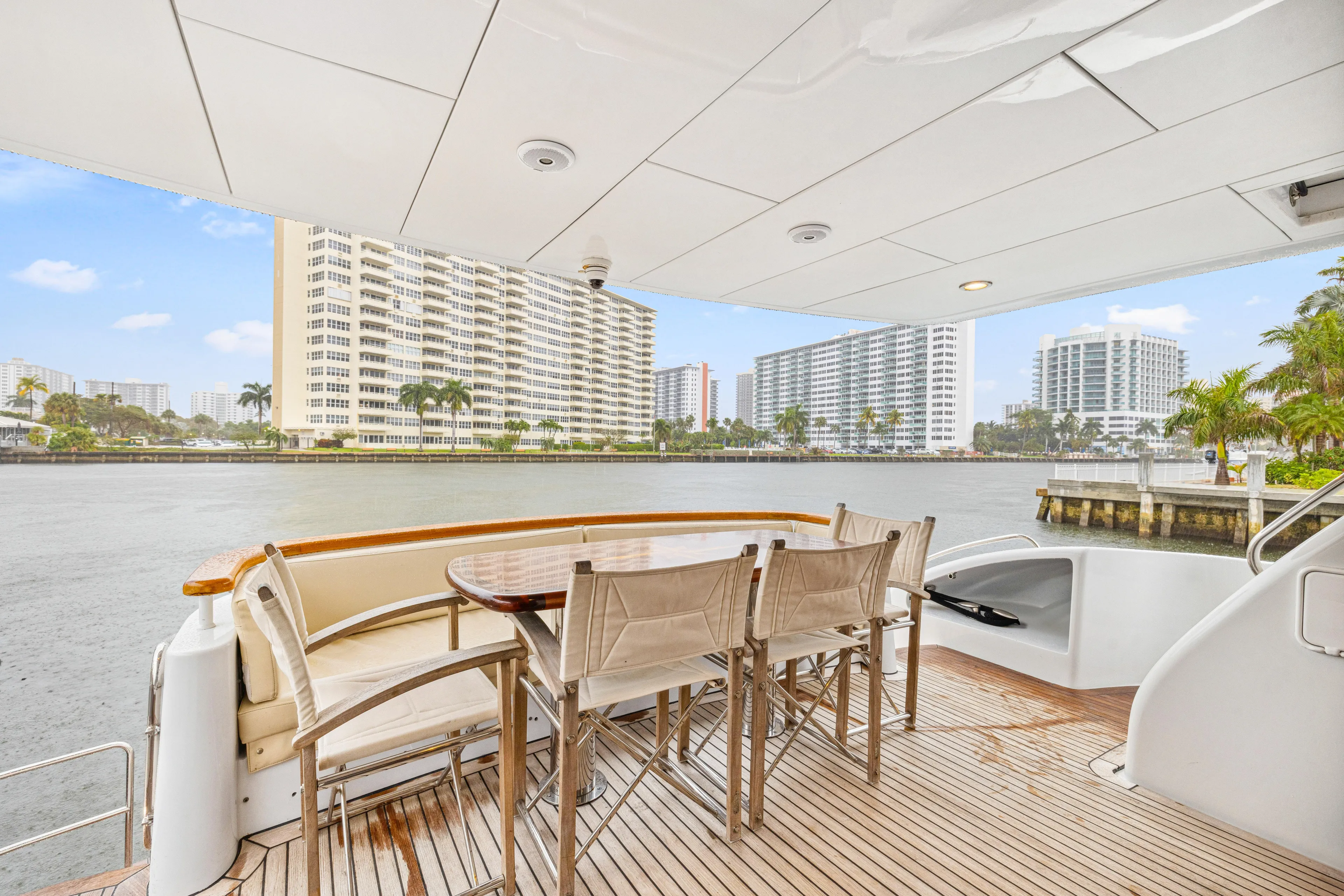 Corporate Approved 2 Yacht Photos Pics Outdoor deck of 2005 Hatteras 80 Motor Yacht with waterfront view and dining area.
