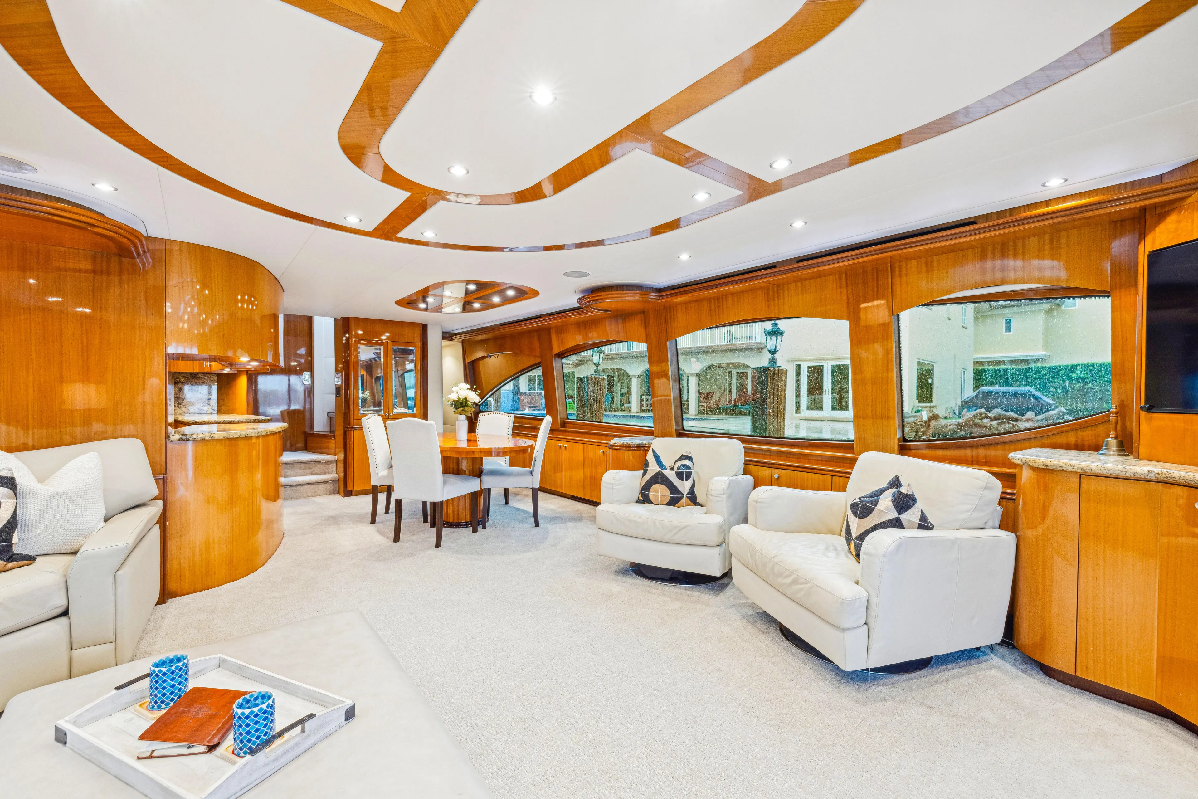 Corporate Approved 2 Yacht Photos Pics Luxurious interior of 2005 Hatteras 80 Motor Yacht with elegant wood finishes and plush seating.