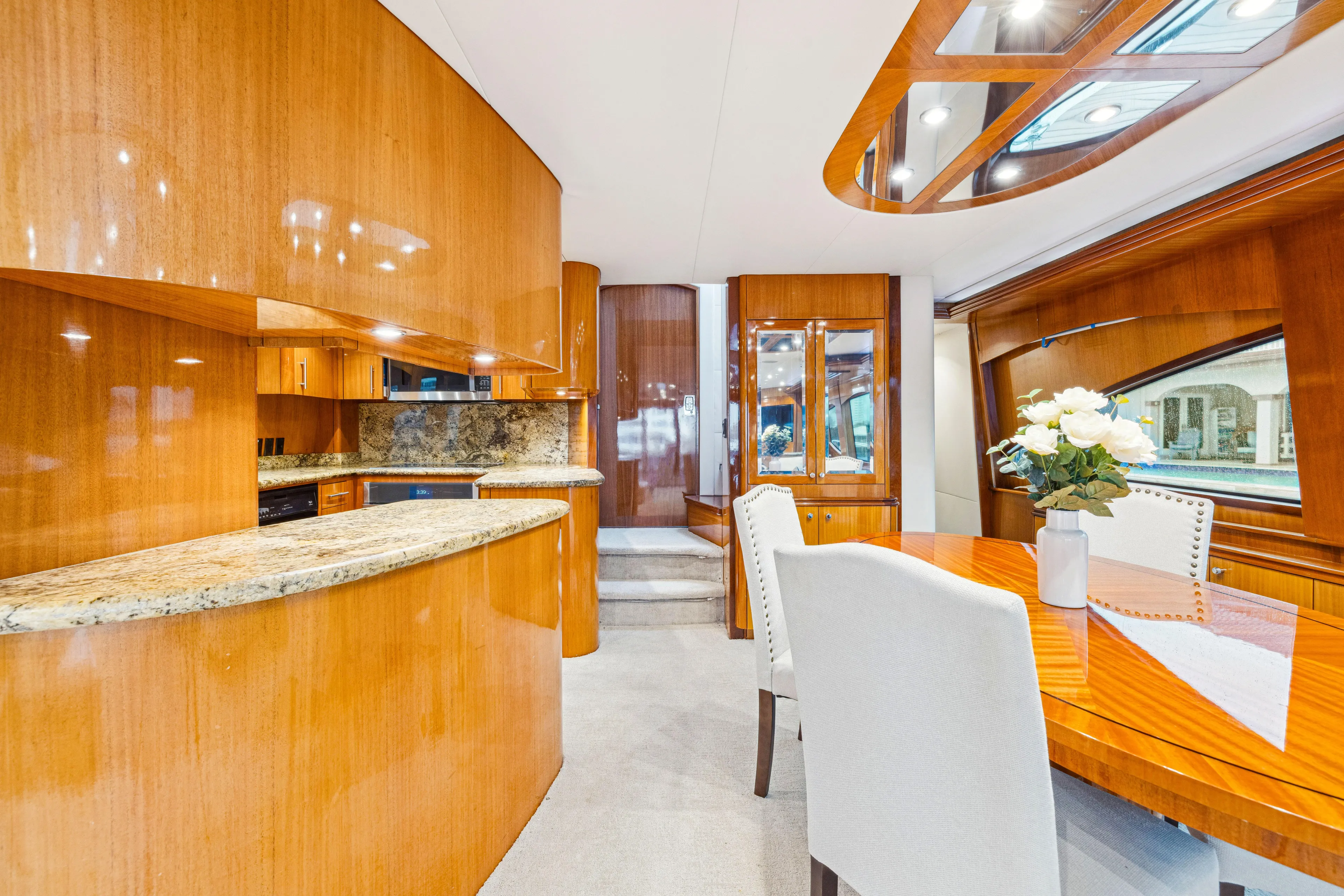 Corporate Approved 2 Yacht Photos Pics Luxurious interior of 2005 Hatteras 80 Motor Yacht with elegant wood finishes and modern dining area.