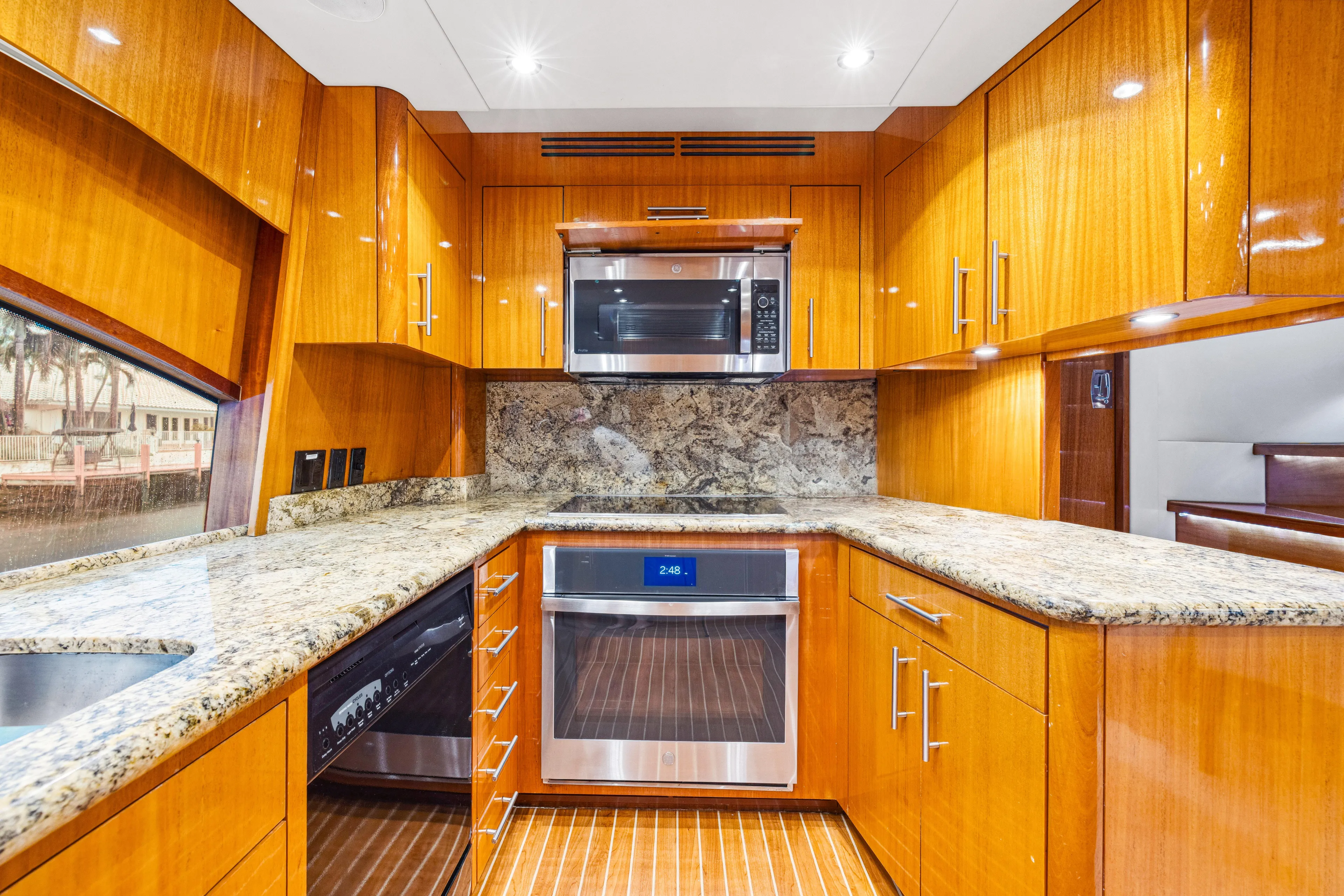 Corporate Approved 2 Yacht Photos Pics Luxurious kitchen in 2005 Hatteras 80 Motor Yacht with wood cabinetry and modern appliances.