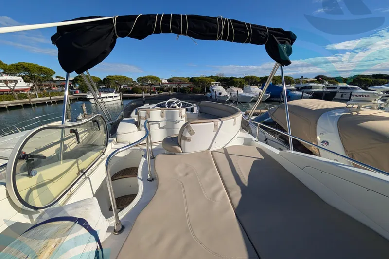  Yacht Photos Pics 2001 Azimut 42 Fly yacht deck with seating, docked in a marina under clear skies.