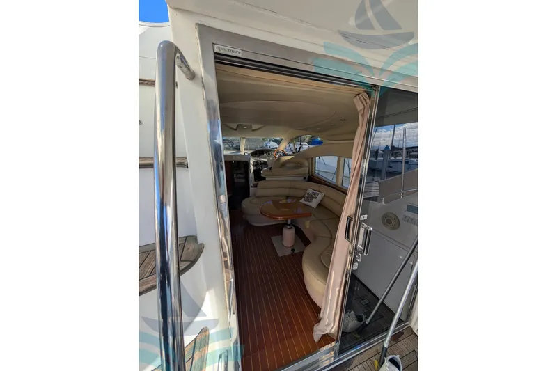  Yacht Photos Pics Interior view of 2001 Azimut 42 Fly yacht, featuring elegant seating and wooden flooring.