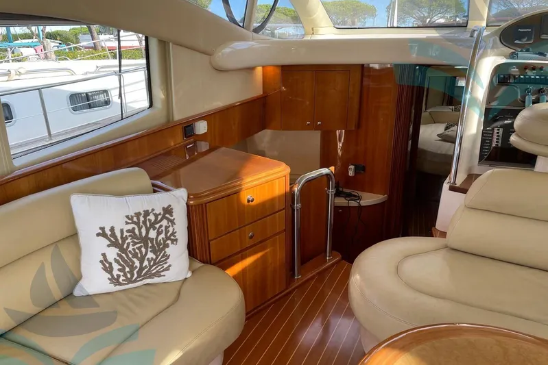  Yacht Photos Pics Luxurious interior of 2001 Azimut 42 Fly yacht with elegant wood finish and plush seating.