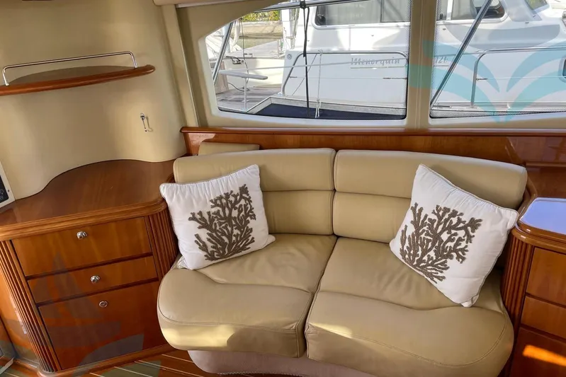  Yacht Photos Pics Luxurious interior of 2001 Azimut 42 Fly yacht with beige leather sofa and decorative pillows.