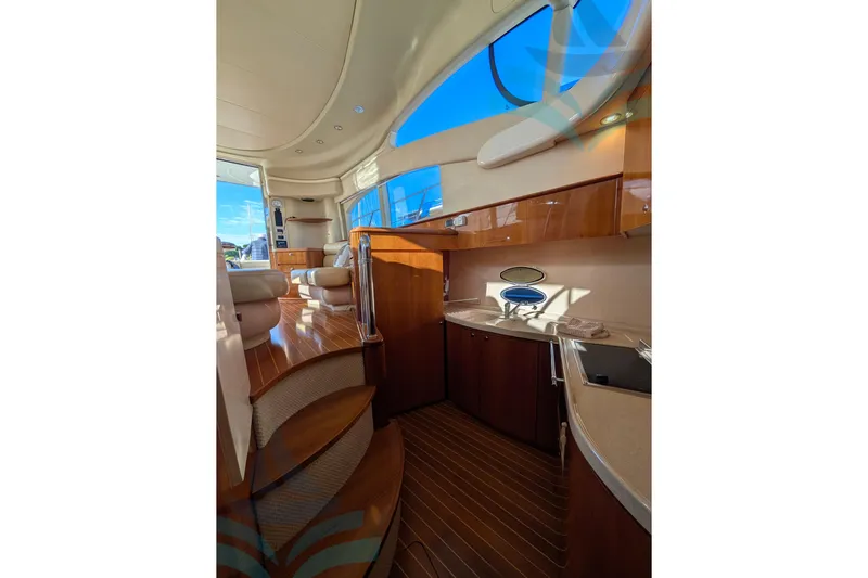  Yacht Photos Pics Luxurious interior of 2001 Azimut 42 Fly yacht with elegant wood finishes and modern amenities.