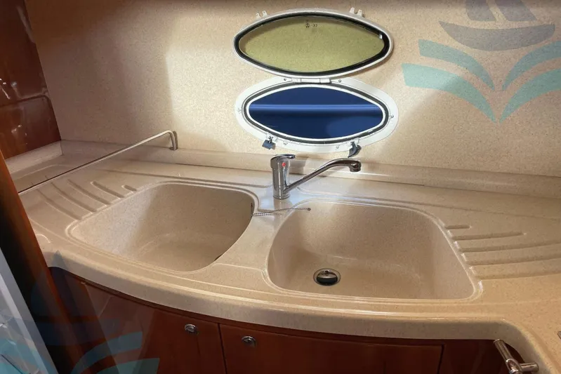  Yacht Photos Pics Kitchen sink area in a 2001 Azimut 42 Fly yacht, featuring dual basins and a window.