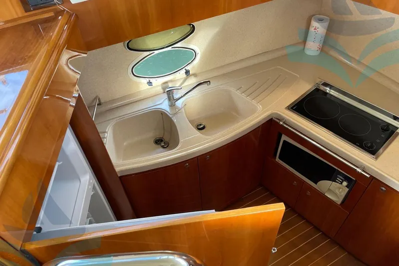  Yacht Photos Pics 2001 Azimut 42 Fly yacht kitchen with sink, stove, and microwave.