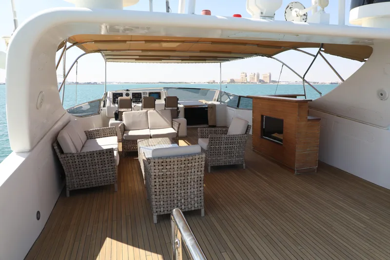  Yacht Photos Pics Luxurious 2005 Falcon 90 yacht deck with wicker seating and ocean view.