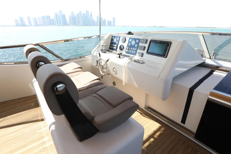  Yacht Photos Pics Luxury yacht cockpit with modern controls, Falcon 90, 2005 model, overlooking city skyline.