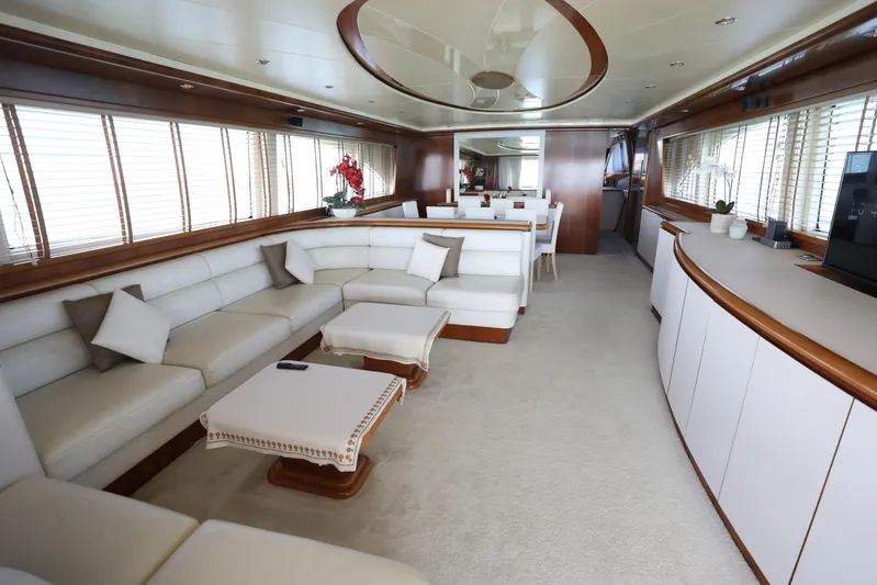  Yacht Photos Pics Luxurious interior of a 2005 Falcon 90 yacht with elegant white seating and wooden accents.