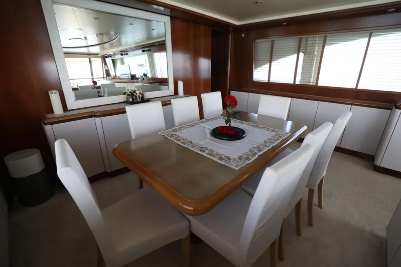  Yacht Photos Pics Luxurious dining area on a 2005 Falcon 90 yacht with elegant decor and seating.