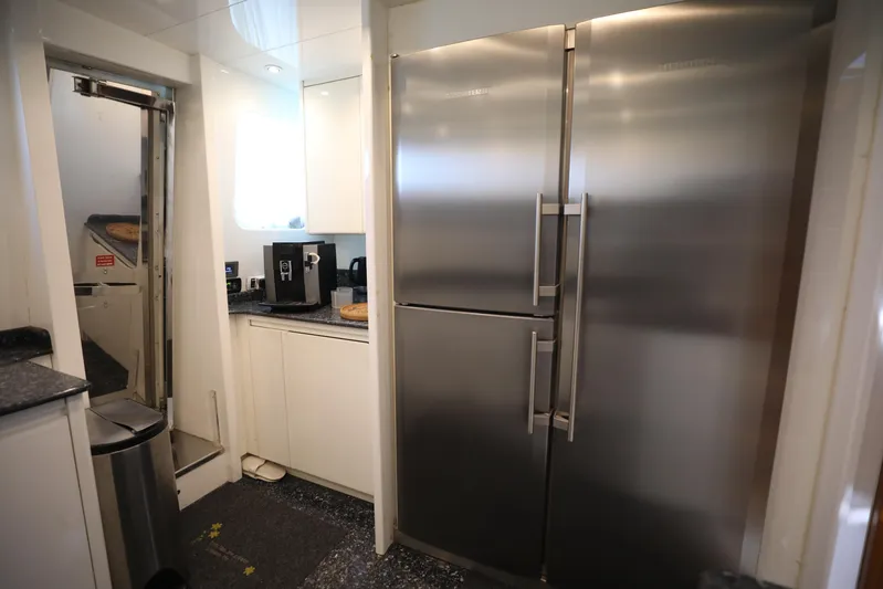  Yacht Photos Pics Modern kitchen with stainless steel appliances in a 2005 Falcon 90 yacht.