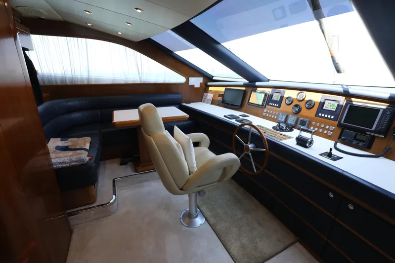  Yacht Photos Pics Luxurious Falcon 90 yacht cockpit interior with modern navigation equipment, leather seating, and wooden accents.